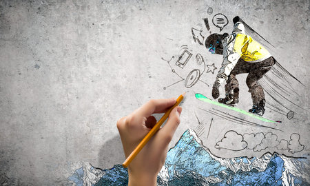 Close up of hand drawing sketches of snowboarder