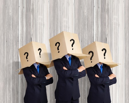 Businessman wearing on head carton box with marksの写真素材