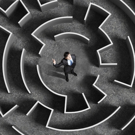 Top view of successful businessman standing in center of labyrinthの写真素材