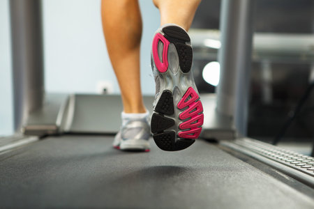 Image of female foot running on treadmill
