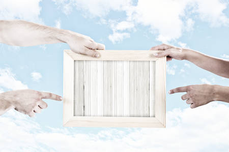 Close up of human hands holding blank frameの写真素材