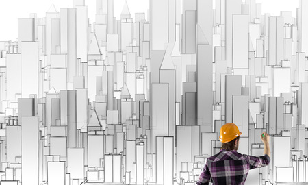 Rear view of engineer drawing project of business districtの写真素材