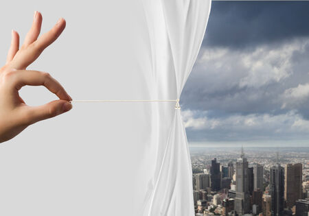 Close up of hand opening the white curtainの写真素材