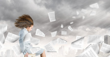 Young businesswoman with waving hair sitting on chairの写真素材