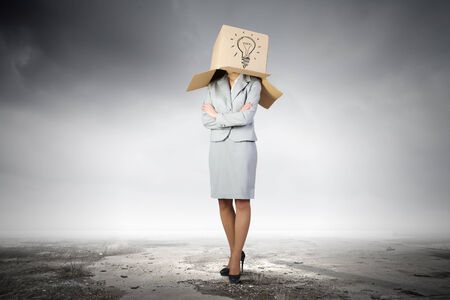 Businesswoman wearing on head carton box with signの写真素材
