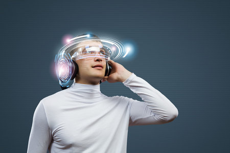 Young handsome man against media backdrop wearing headphones
