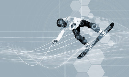 Male snowboarder making jump against media background