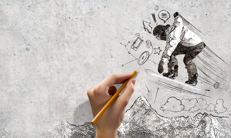 Close up of hand drawing sketches of snowboarderの写真素材