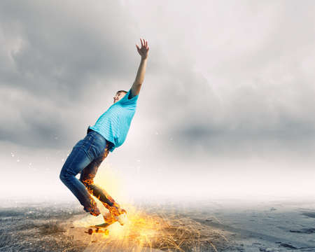Skater in jeans riding on top of buildingの写真素材