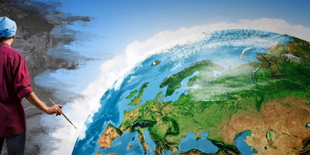 Young handsome man painter with brush in hand の写真素材