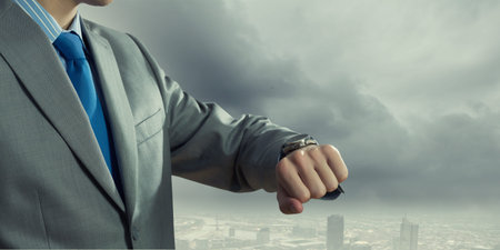 Close up of businessman looking at watch