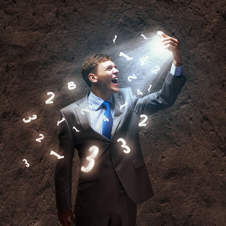 Angry businessman screaming furiously in to mobile phoneの写真素材
