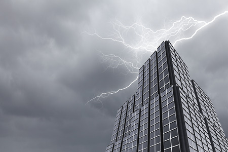 Bottom image of skyscraper with thunder lightning in skyの写真素材