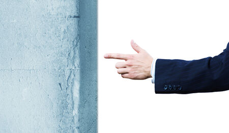 Businessman in suit pointing at huge stoneの写真素材