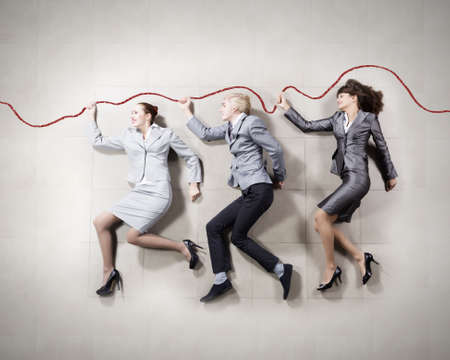 Young people in business suits lying on floorの写真素材