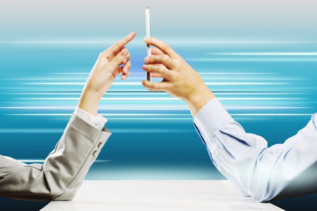 Close up of people hands using mobile phone