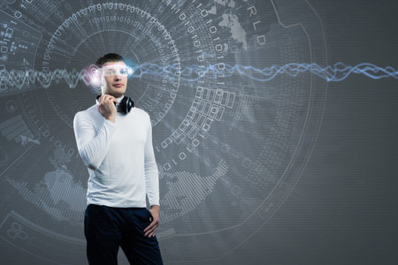 Young man wearing headphones against media background  New technologies