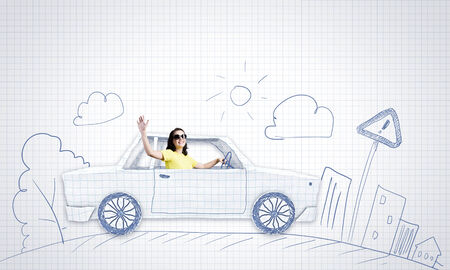 Young woman riding car made of list of paperの写真素材