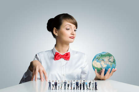 Young smiling woman holding Earth planet in hand の写真素材