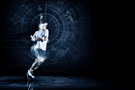 Young running man against digital media backgroundの写真素材