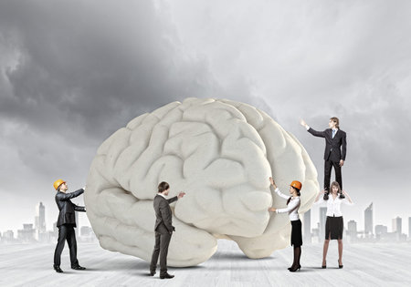 Huge human brain and many little businesspeople around