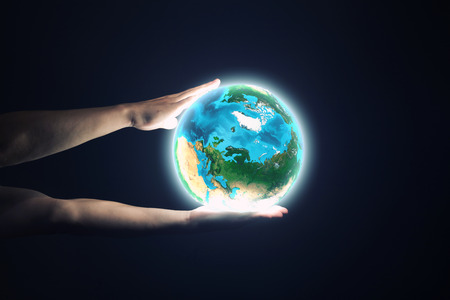 Close up of human hand holding Earth planet  の写真素材