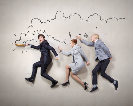 Young people in business suits lying on floorの写真素材