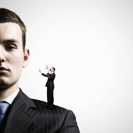 Miniature of businessman screaming in megaphone standing on boss shoulderの写真素材
