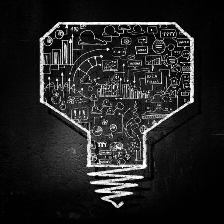 Conceptual image of light bulb on black wallの写真素材