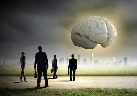 Huge human brain and many little businesspeople aroundの写真素材