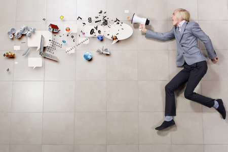 Funny image of running businessman holding megaphoneの写真素材