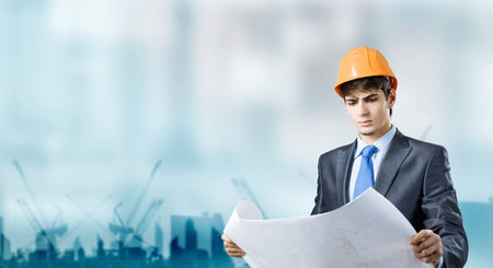 Young man architect looking at construction project