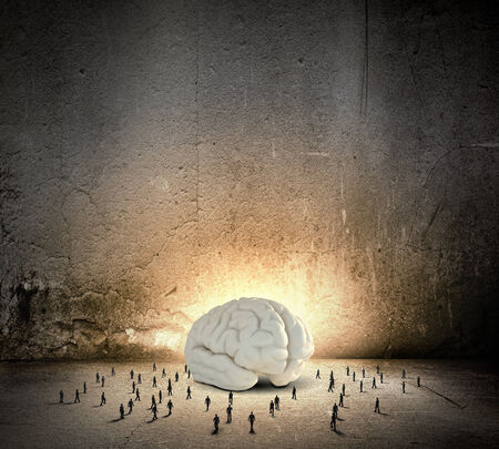 Huge human brain and many little businesspeople aroundの写真素材