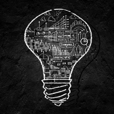 Conceptual image of light bulb on black wallの写真素材
