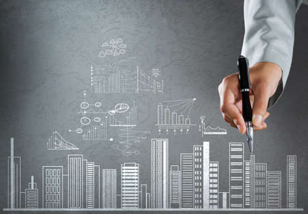 Close up of businesswoman hand drawing business sketchesの写真素材