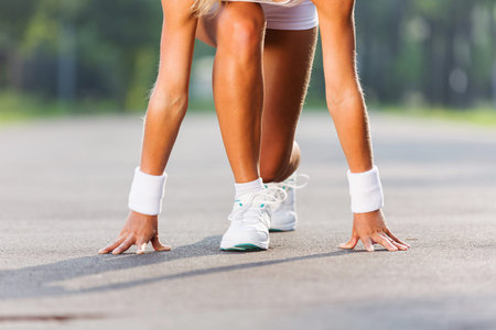 Bottom view of young sport woman in start pose