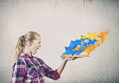 Young pretty woman in casual holding opened bookの写真素材