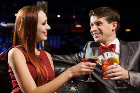 Young handsome man accompanied by elegant ladyの写真素材