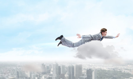 Young super businessman flying high in sky