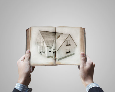 Close up of male hands holding opened bookの写真素材