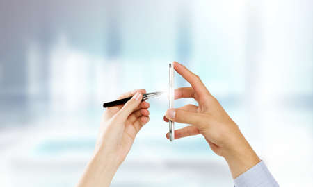 Close up of people hands using mobile phoneの写真素材