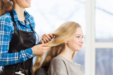 Young woman in chair at barbers and hairdresserの写真素材