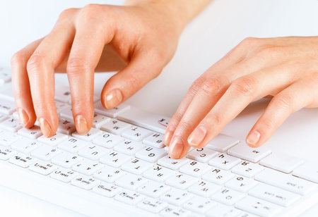Close up of female hands typing on keyboard