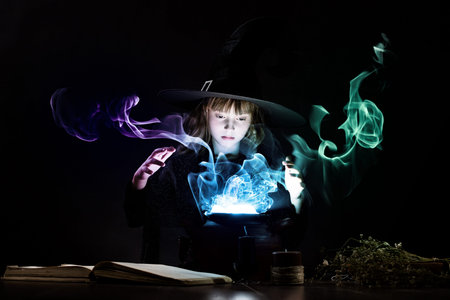 Little Halloween witch reading conjure above pot