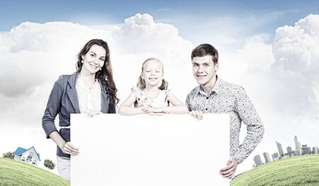 Young happy family with white blank banner  Place for textの写真素材