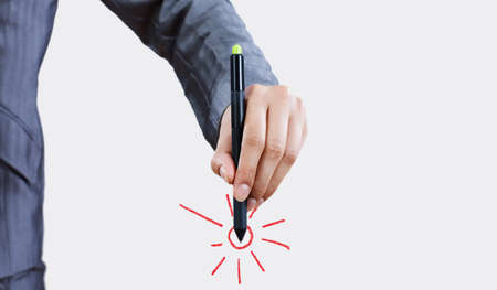 Close up of businessman hand drawing sunの写真素材