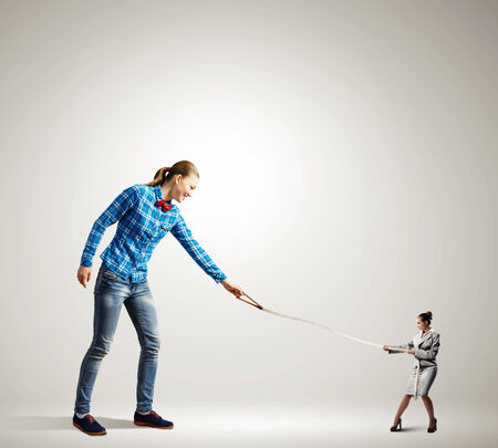 Woman holding on lace businesswoman trying to escapeの写真素材