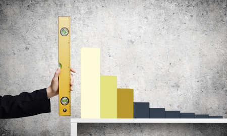 Close up of female hand measuring graph with rulerの写真素材