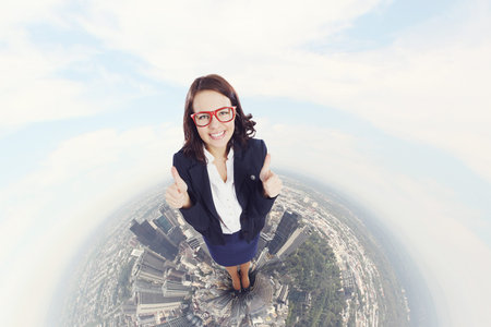 Top view of young pretty businesswoman with thumbs up