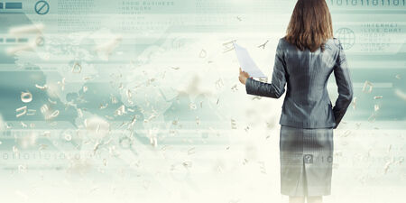 Back view of businesswoman holding papers in handsの写真素材